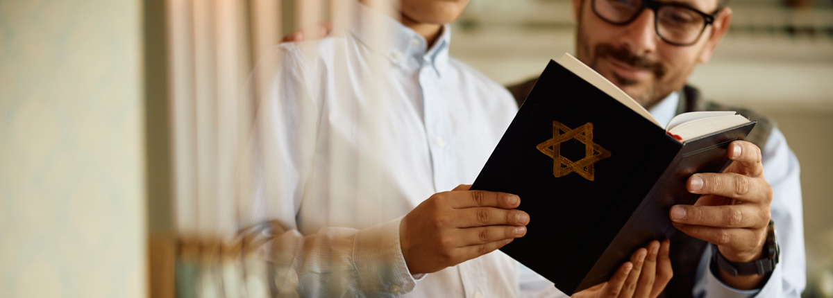 4close-up-of-father-and-son-reading-hebrew-bible-on-2023-11-27-05-12-15-utc.jpg